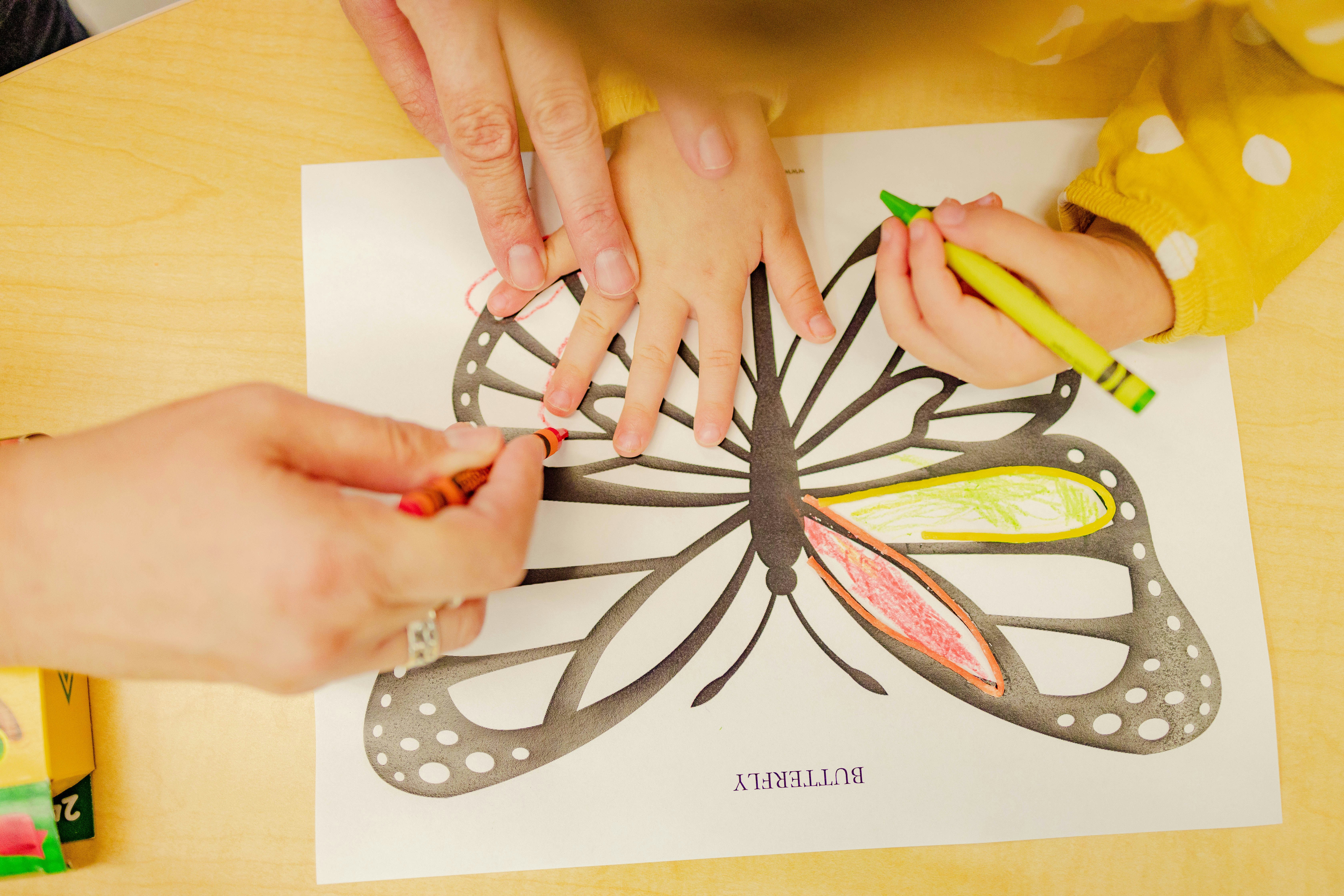 child drawing a butterfly