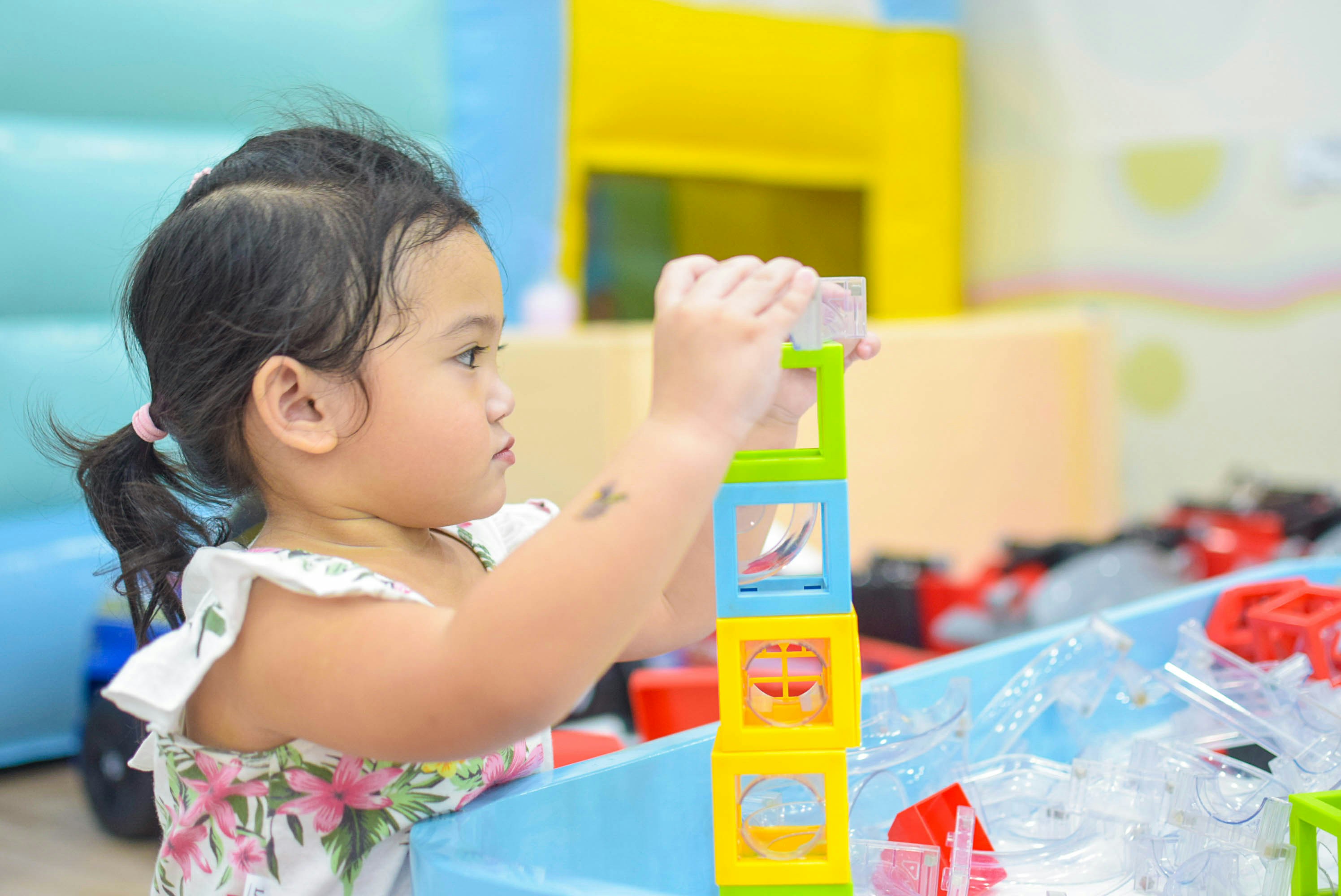 little girl playing with building blocks