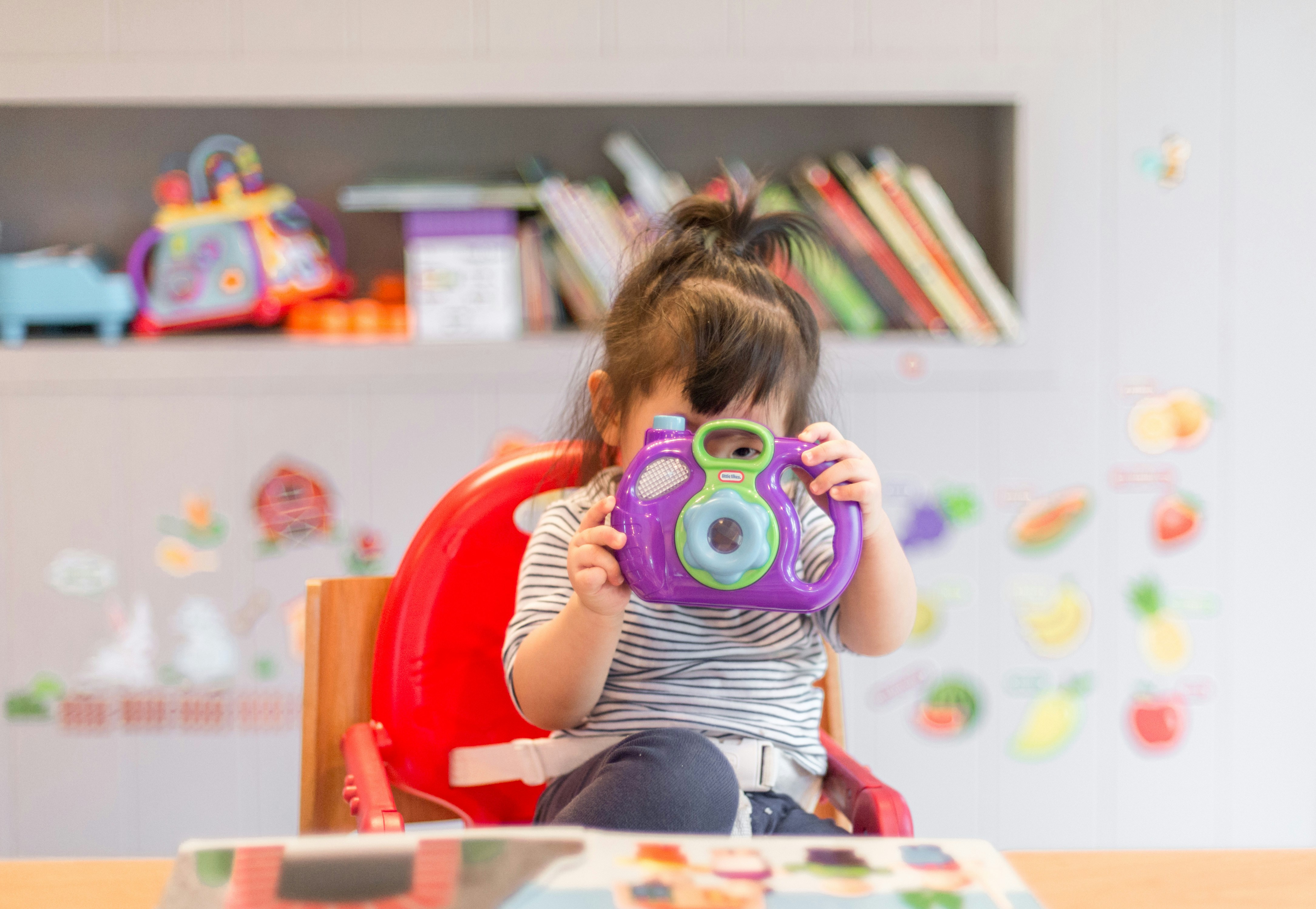 toddler with camera